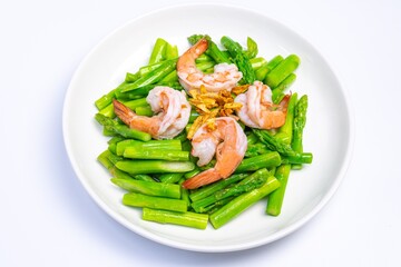 Stirred fried asparagus with shrimp served on white plate isolated on white background. famous thai food in thailand. popular food in Asia.