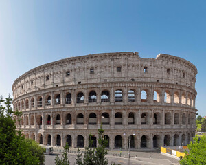 Fototapeta na wymiar Rome Italy, impressive view of the Colosseum ancient amphitheater under clear blue sky