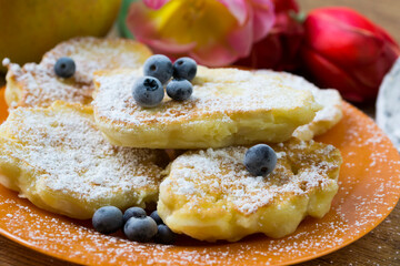Racuchy - small pancakes with apples and blueberries. Perfect hot breakfast.