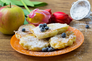 Racuchy - small pancakes with apples and blueberries. Perfect hot breakfast.
