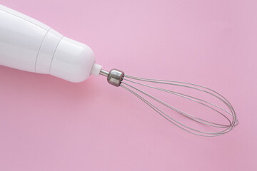 Electric blender with a whisk for mixing eggs. The mixer is used to make cream.