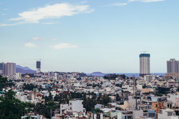 Fototapeta premium Nha Trang, Vietnam: Top view of houses and buildings in Vietnam on a hot Sunny day with a cloudy sky