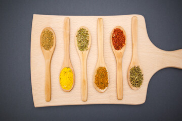 Various kind of spices for food in wooden zero waste spoons. Organic healthy concept 