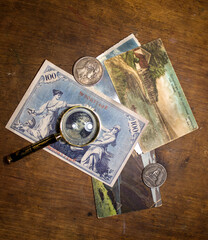 isolated on background, old money banknotes and coins with magnifying glass 