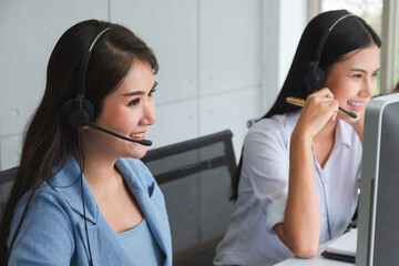 Professional call center woman advising a customer on the telephone.