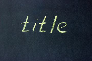 Chalkboard with the phrase "title" written. Creating a title is part of the copywriter's job