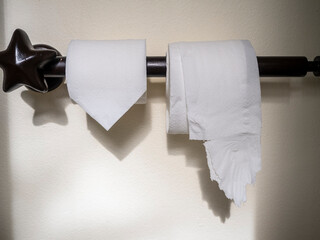 Neat and wrinkled toilet paper. comparison concepts.