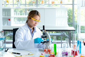 Young scientist looking through a microscope in a laboratory. Health care researchers working in life science laboratory