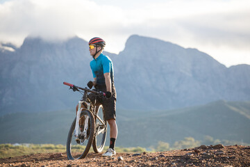 Fototapeta premium Close up portrait of a mountain biker on his mountain bike on a bike track