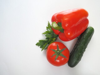 Tomato and sweet red pepper, bell pepper, cucumber, parsley isolated on white background