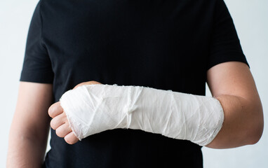 A broken hand in a gypsum bandage. Painful heavy movements of broken finger hands close-up