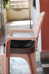 Black memory foam cushion in a plastic chair