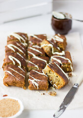 Closeup of blondies, pastry made from white chocolate (similar to brownies), cut into square pieces, on light background