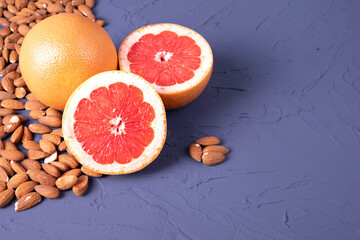 two ripe and juicy halves of grapefruit and almonds