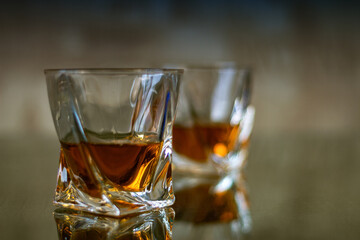 Glasses of whiskey are on the table. Tinted photo with filter