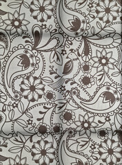 The print on the fabric depicts a pattern with a bird in brown colors