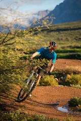 Fototapeta premium Close up image of a mountain biker speeding downhill on a mountain bike track