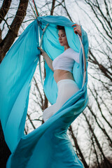 girl in white on a Hoop in the woods
