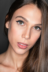 Obraz premium Close-up portrait of beautiful young woman looking in camera, shot on studio, green eyes