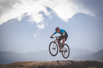 Close up image of a mountain biker speeding downhill on a mountain bike track