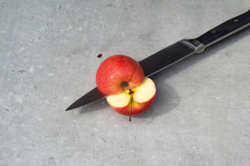 Cutting an apple fresh fruit preperation inside a kitchen on a chopping board