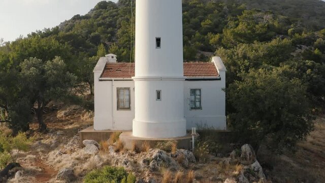 Lighthouse on the hill. Mountains on the background covered by green trees. Turkey 4K