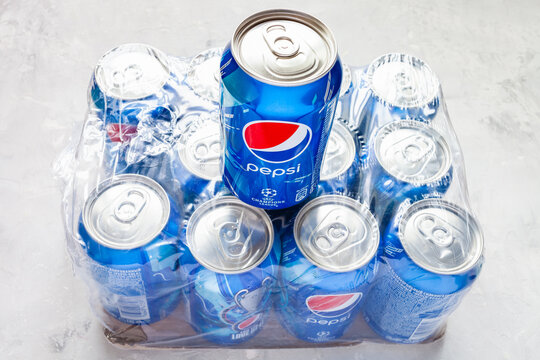 MOSCOW, RUSSIA - JUNE 17, 2020: above view of can of Pepsi with logo of UEFA Champions League over pack of dozen cans on concrete floor. Pepsi is carbonated soft drink manufactured by PepsiCo