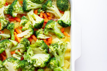 Raw vegetables on a baking tray. Cooking vegetables for baking in oven dish top view. Selective focus