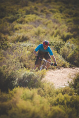 Close up image of a mountain biker speeding downhill on a mountain bike track