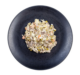 top view of portion of russian Olivier salad on black plate isolated on white background