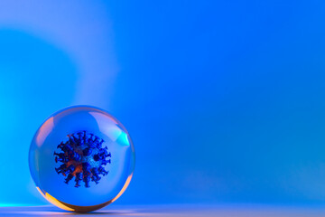 Virus of COVID-19 inside the cell. Mockup of virus in a glass sphere, coronavirus abstract concept on blue background.