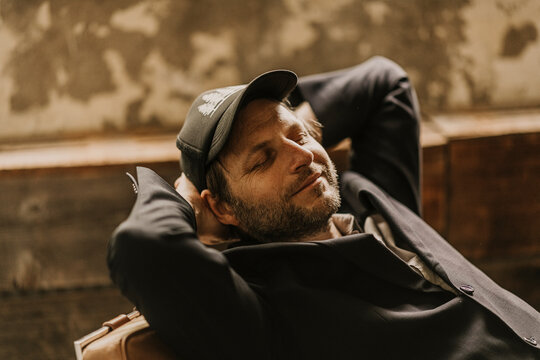 Europe, Germany, Hamburg, Hafencity, creative guy relaxing in office.