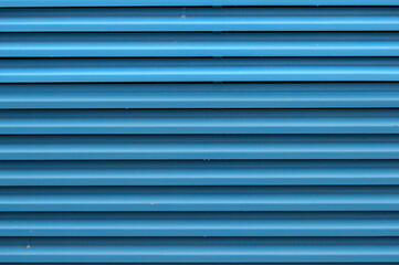 Blue metallic background with vertical stripes in a facade of building in Madrid. Spain.