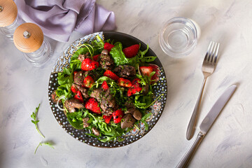 Chicken liver salad with strawberries. View from above, top view