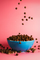 Chocolate breakfast cereals falling into the bowl, concept of breakfast and morning, selective focus, dynamic picture