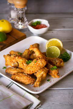 Deep fried chicken wings on white plate. Vertical image