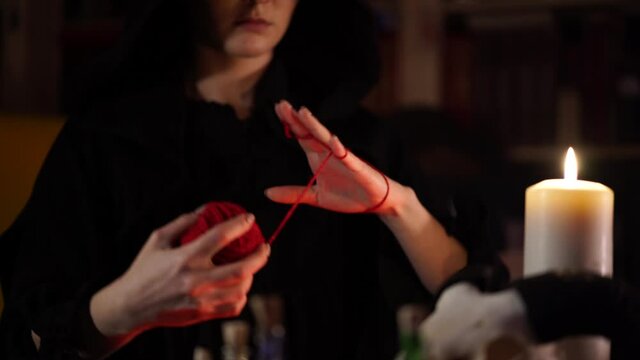 session of black magic with a red thread