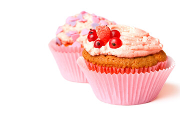 Vanilla muffins with whipped cream, currants and decorative sprinkles