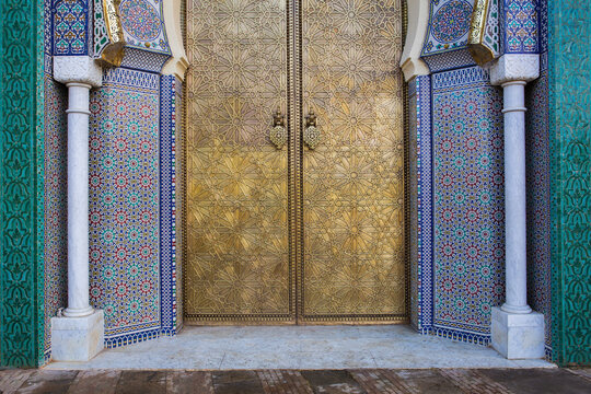 Closeup view of the golden door and ornate tile work of the Royal Palace in Fez, Morocco
