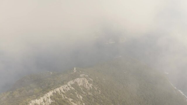 Gelidonya lighthouse in the clouds. Beautiful landscape from above. Aerial view. 4K