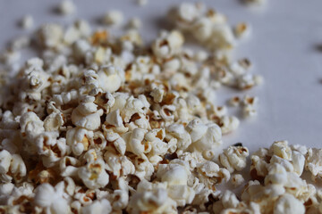 close up of popcorn on a white background