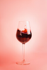Red wine splash in a glass, dynamic picture, selective focus.
