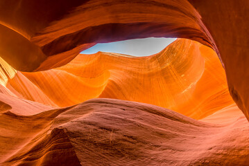 The upper walls of the slot canyon glow in the morning sunshine in lower Antelope Canyon, Page, Arizona