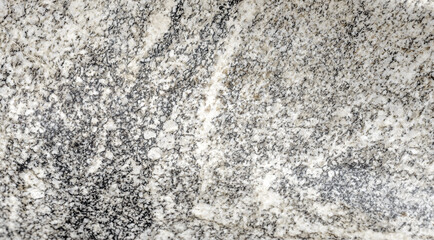 Natural stone grey granite background. Bright hard grey granite rock texture. Grey granite stone background. Grey granite untreated surface. Facing material full frame horizontal texture. Granite