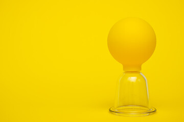 yellow vacuum jars for massage against cellulite on a yellow background