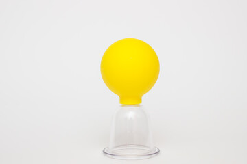 yellow vacuum jars for massage against cellulite on a white background