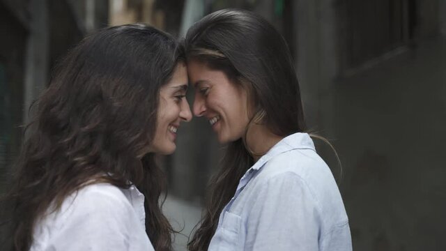 Lesbian girls couple look each other in the eye. LGBT