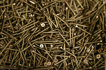 Background of metal nails top view close-up. Background from a variety of building steel sharp nails macro. A big pile of nails. Гвозди. Шурупы. 
