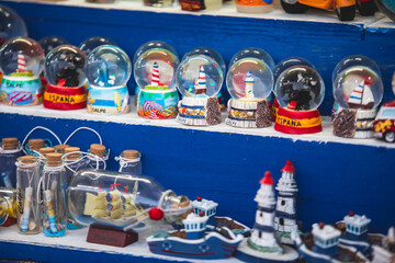 View of traditional tourist souvenirs and gifts from Calpe, Calp, Alicante, Valencia with toys, fridge magnets with and key ring keychain, in local vendor souvenir shop
