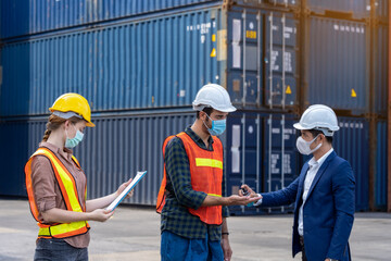 Engineer assistant inspector protect body by wearing mask,helmet and wash hand with alcohol Before entering warehouse or factory Prevent accident from work dust and Coronavirus. New normal concept